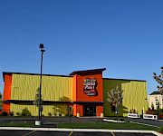 An orange-and-green Family Fun Center building with a “Seekonk Grand Prix” sign under a blue sky.